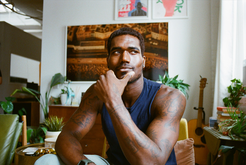 Boy Radio posing with a colorful background